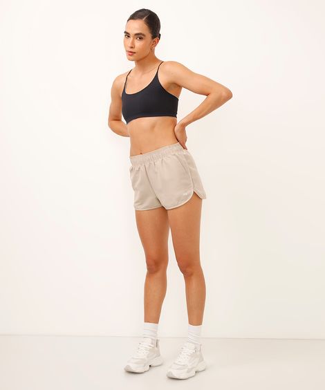 short running feminino com bolso esportivo bege