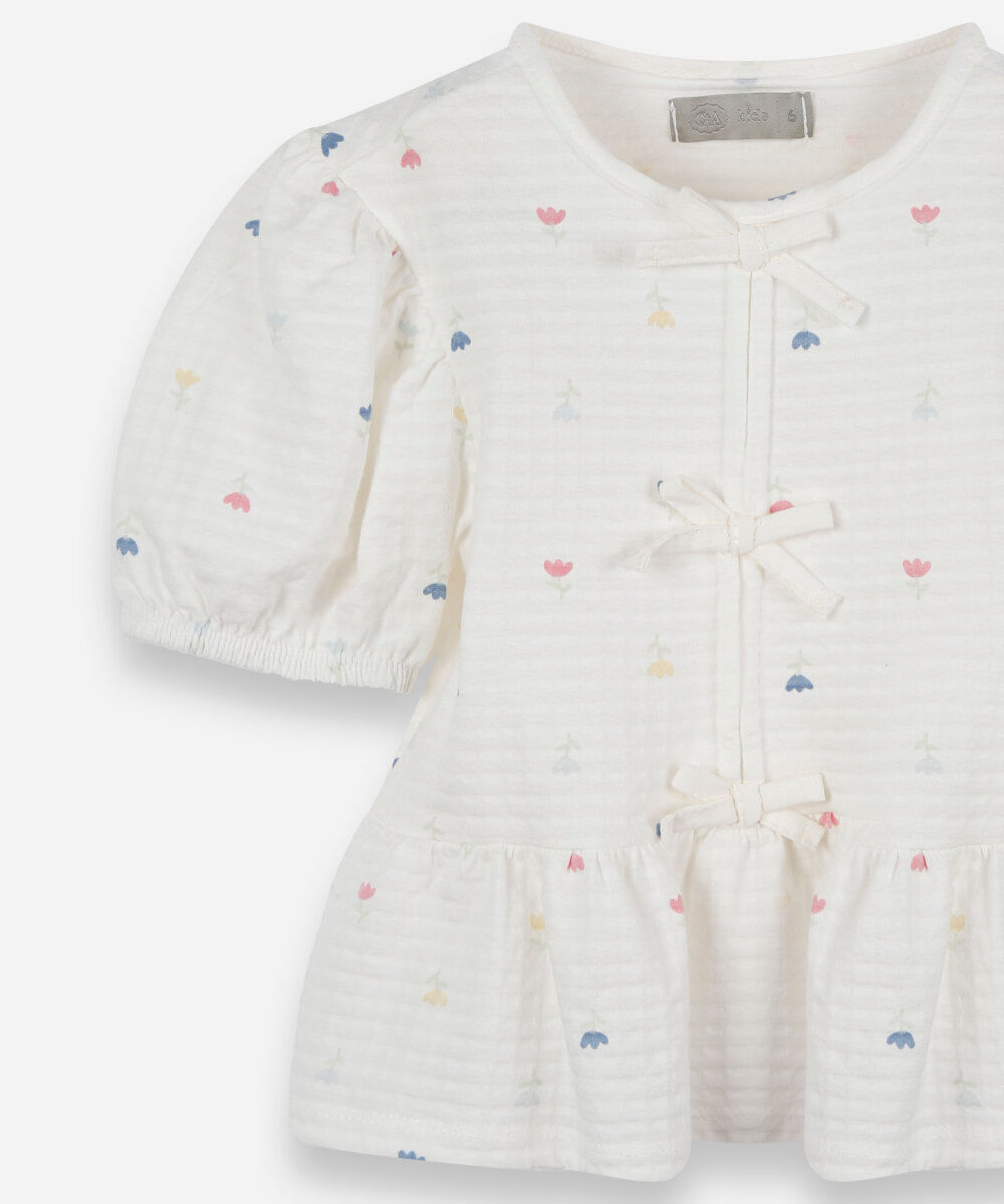blusa infantil peplum de malha texturizada com laços e manga bufante off white
